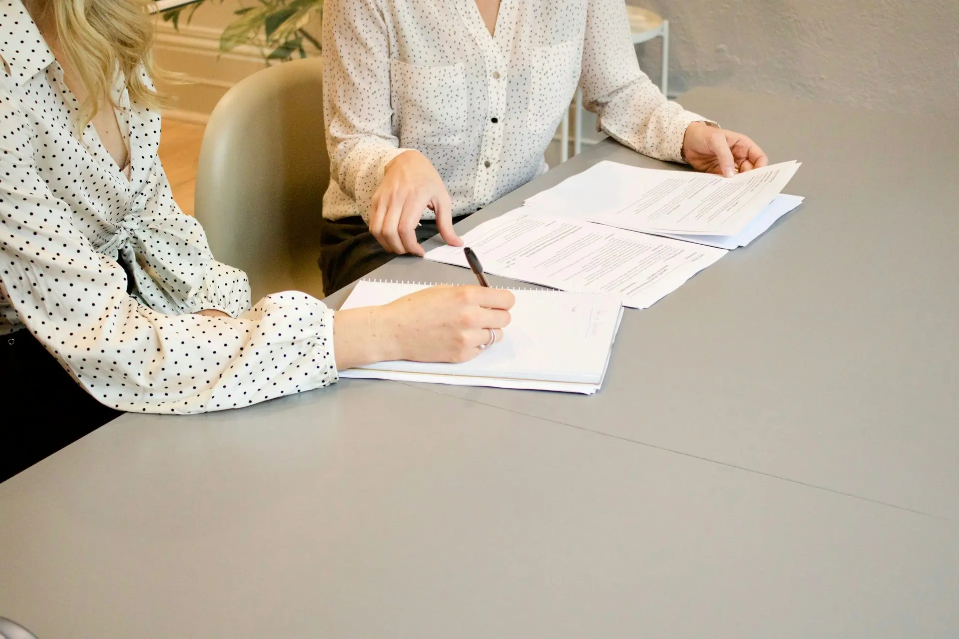 Two people reviewing a contract
